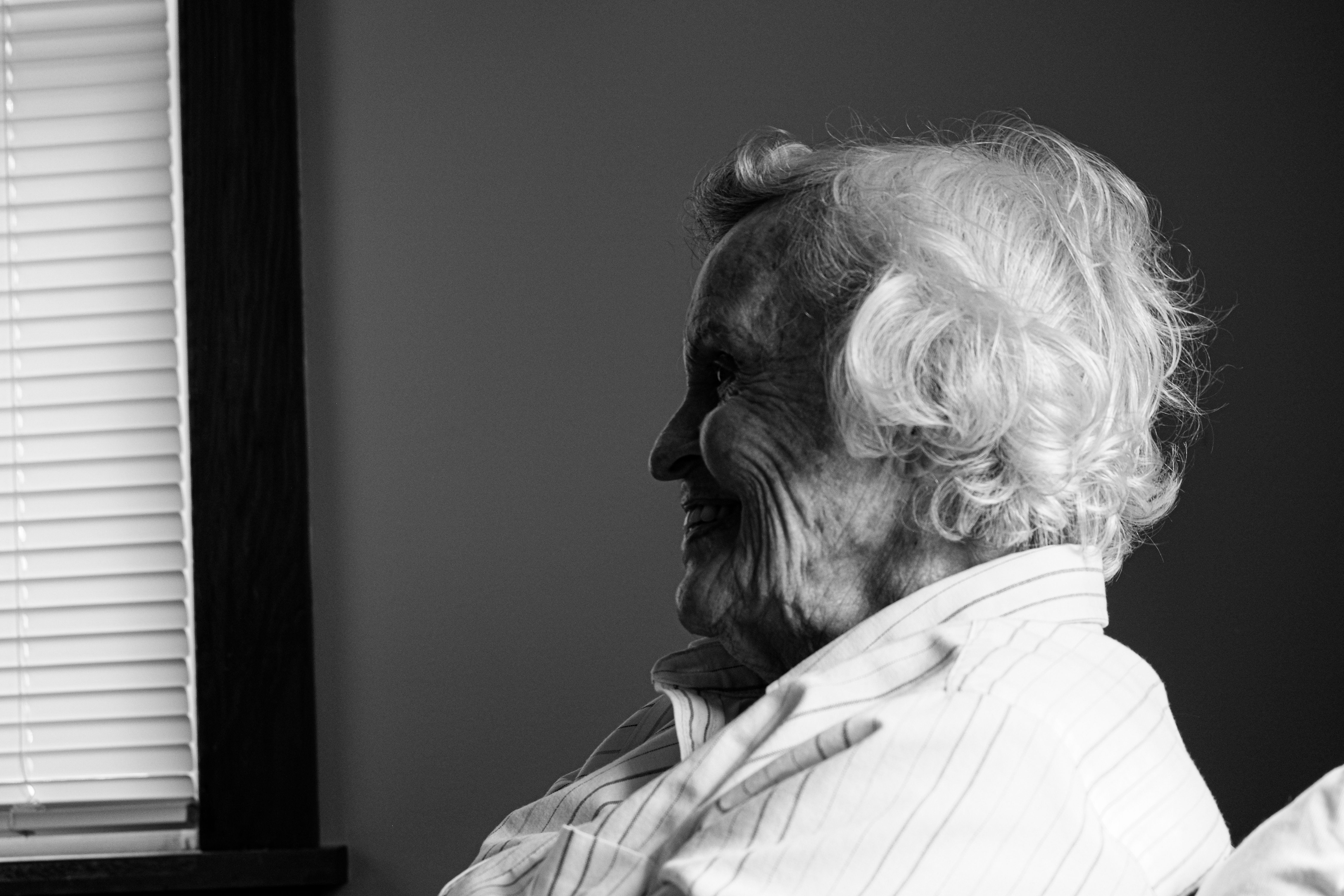 An elderly woman smiling in a professional portrait.