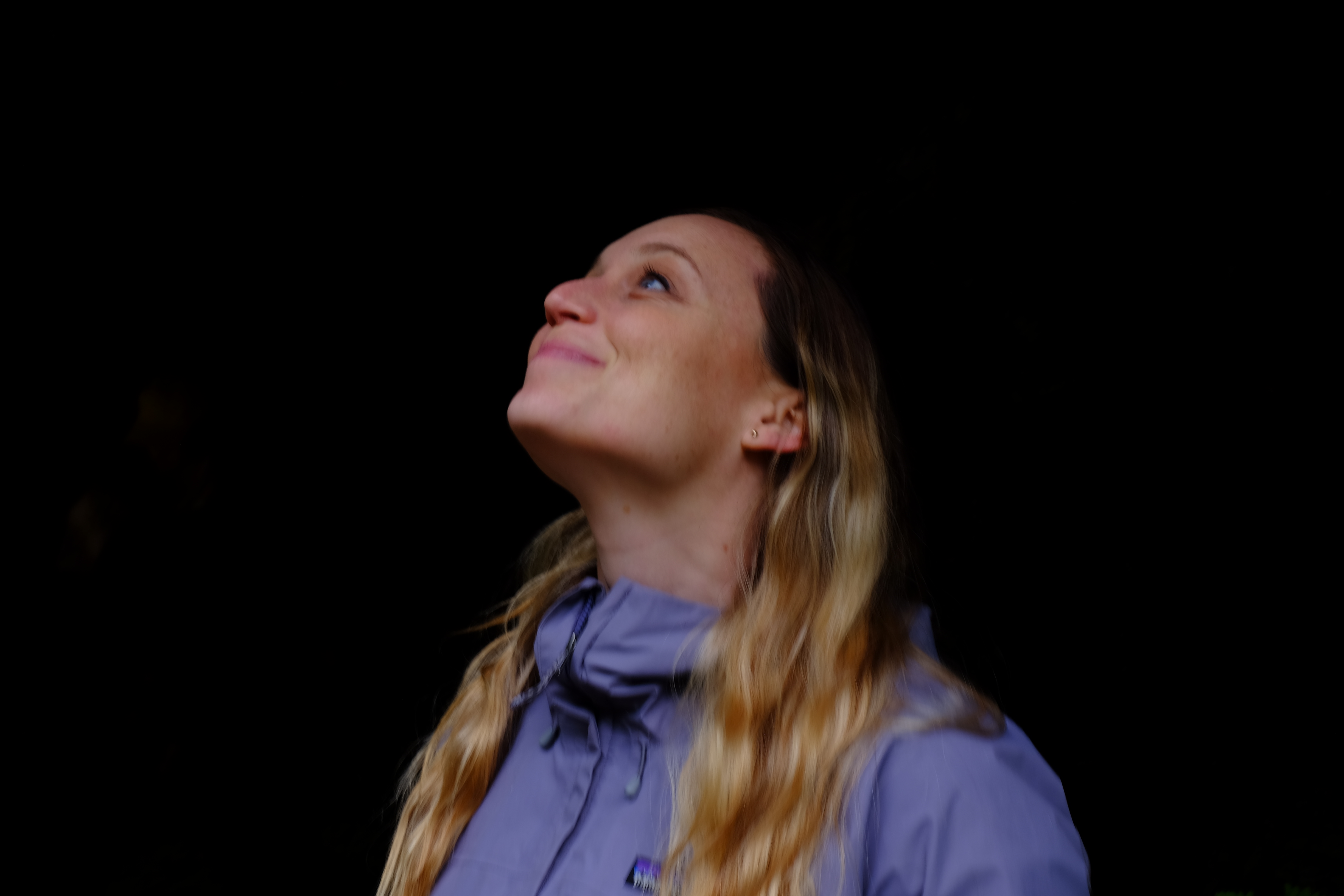 A photograph of a young woman in nature.