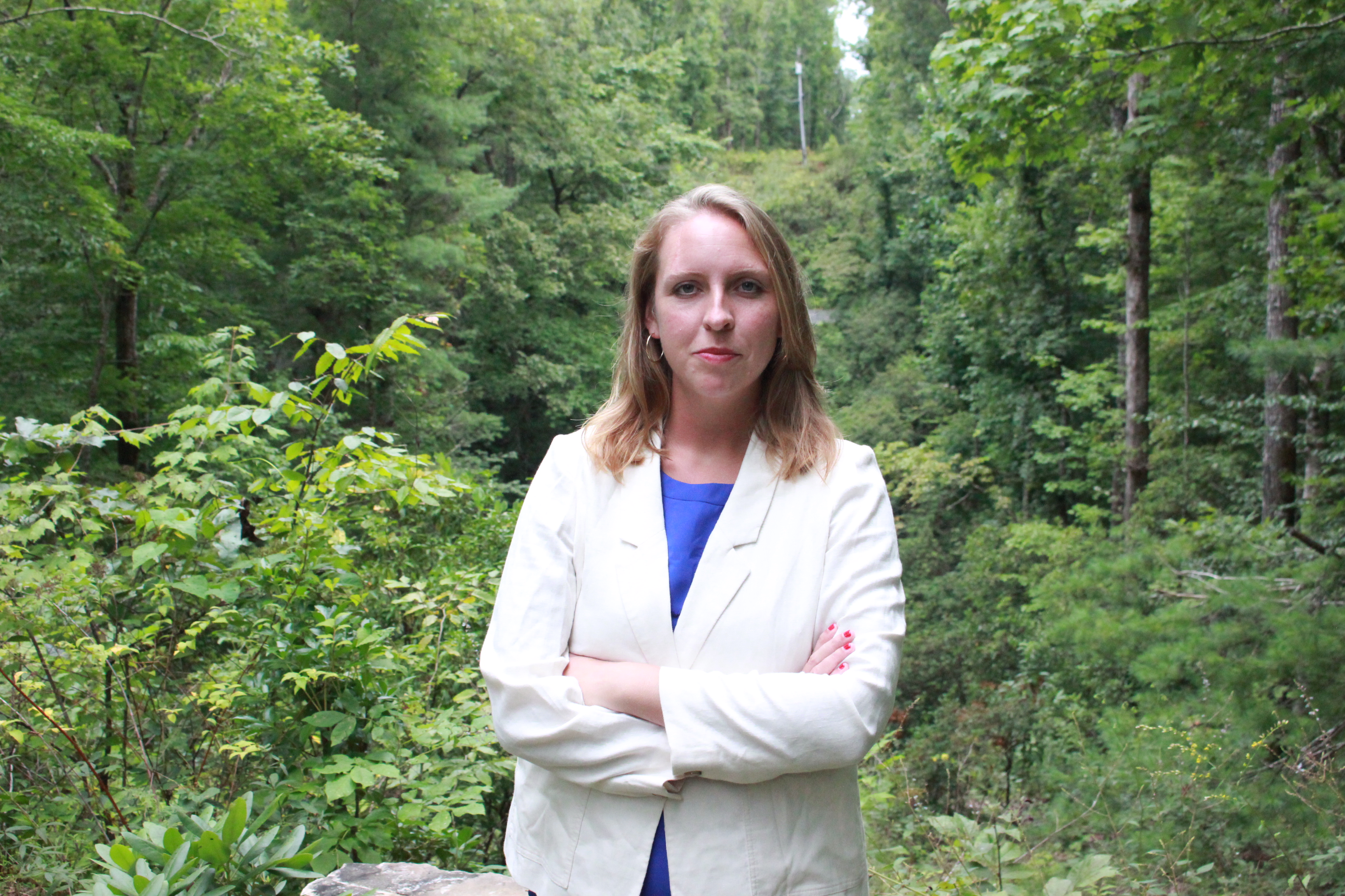 Headshot of a successful businesswoman at a woodland retreat.